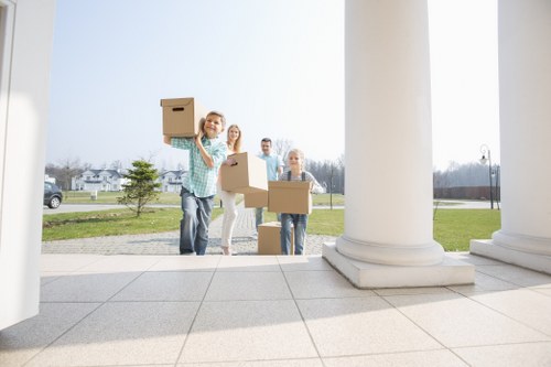 Professional movers handling boxes in a St Johns Wood apartment move