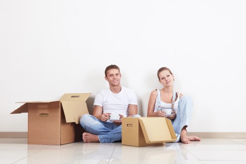 Local van removal team handling boxes and furniture carefully
