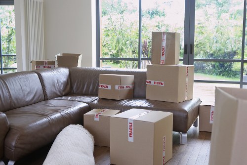 Loading moving boxes into a van on a residential London street